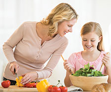 mother and daughter are preparing a meal together