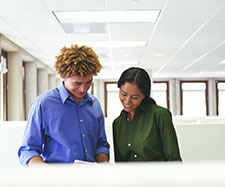 coworker showing document to another colleague coworker showing document to another colleague